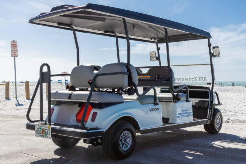 6 Pass Villager 205 Back Right Angle A golf cart with seats on the back of it.