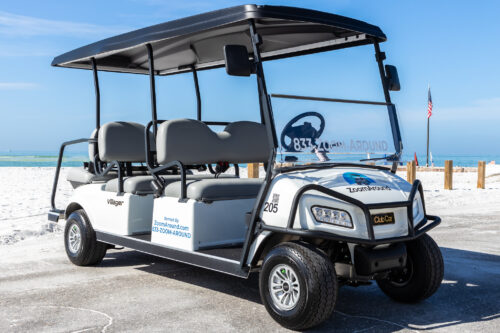 6 Pass Villager 205 Right Front Angle (2) A white and black golf cart parked on the beach.